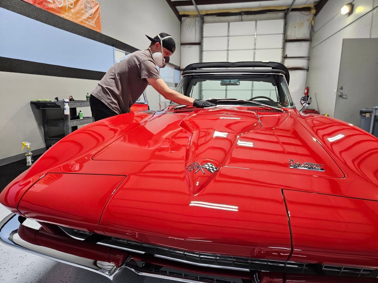 Classic red Chevrolet Corvette Sting Ray undergoing paint correction at Renegade Auto Spa