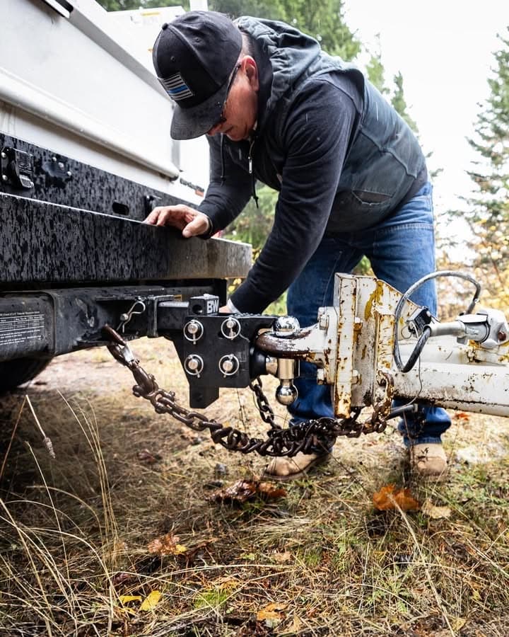Hooking a trailer coupler to a B&W tri-ball receiver hitch with safety chains