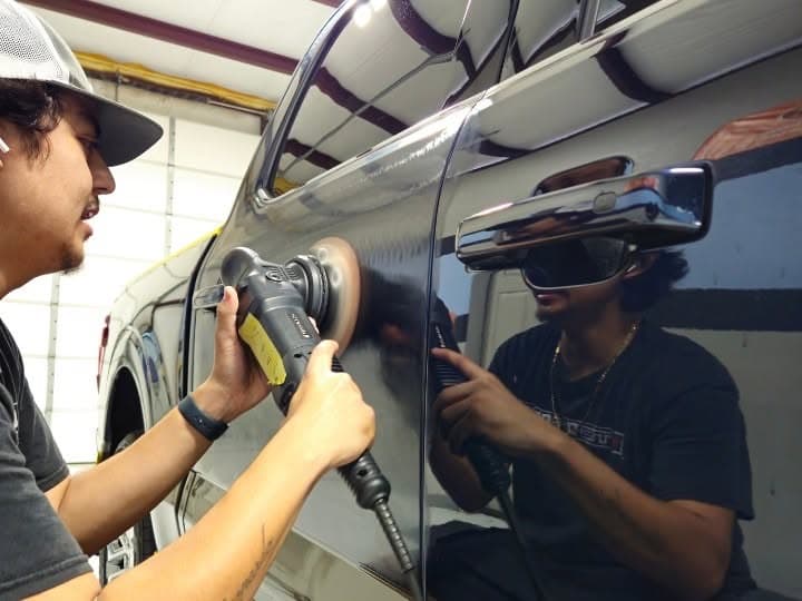 Renegade Auto Spa crew machine-polishing a black truck