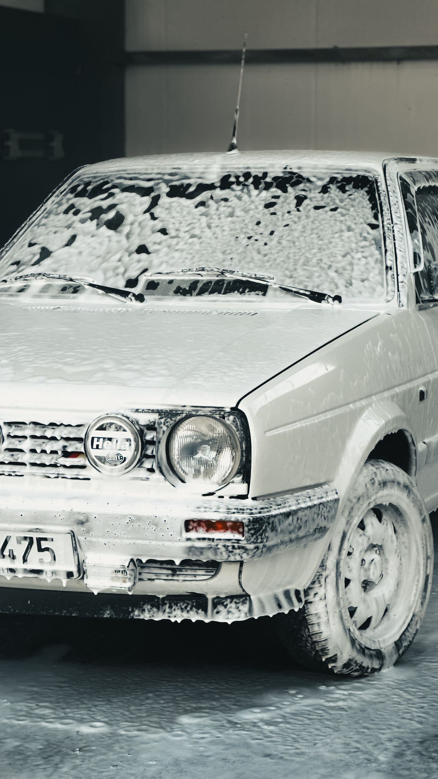 Vehicle covered in snow foam during a detail wash